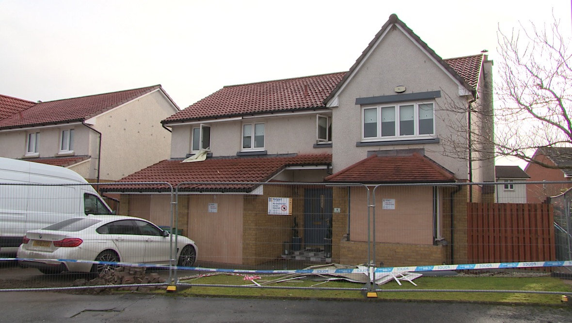 Damage: The house has been boarded up.