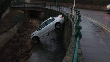 Driver’s lucky escape after car crashes into burn