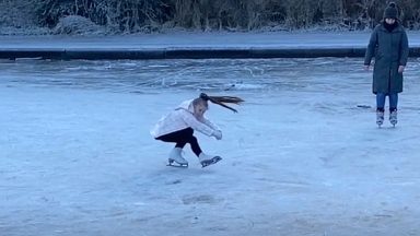 Nine-year-old shows off ice skating skills on frozen street