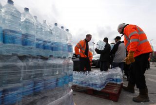 Divers clear ice blockage to restore water to thousands