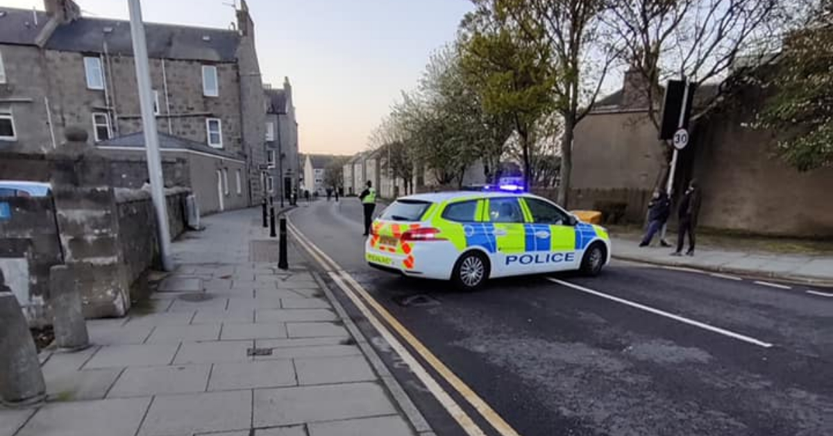 Armed police lockdown city street amid ongoing incident