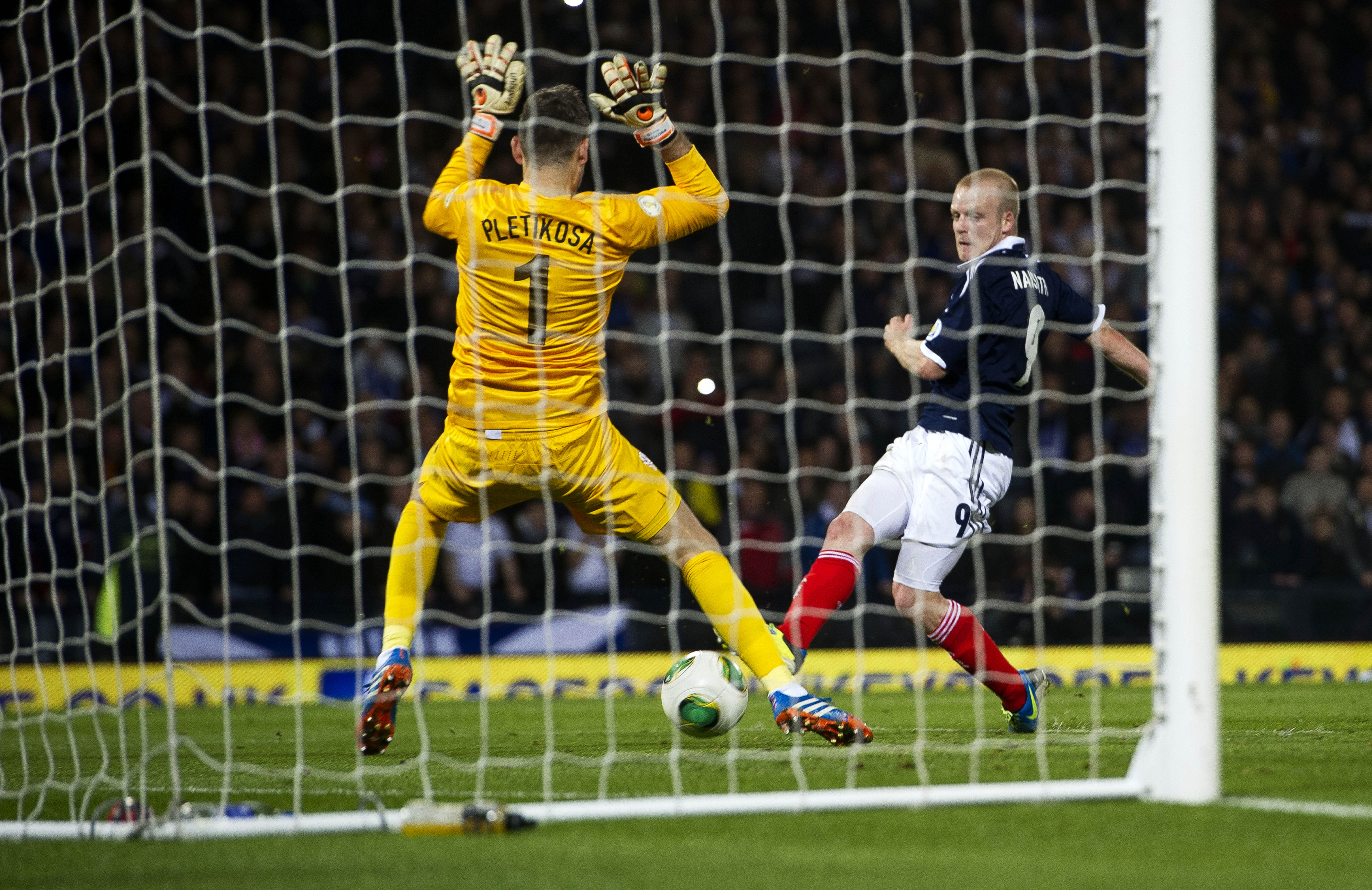 Steven Naismith slots home his side's second goal of the game.