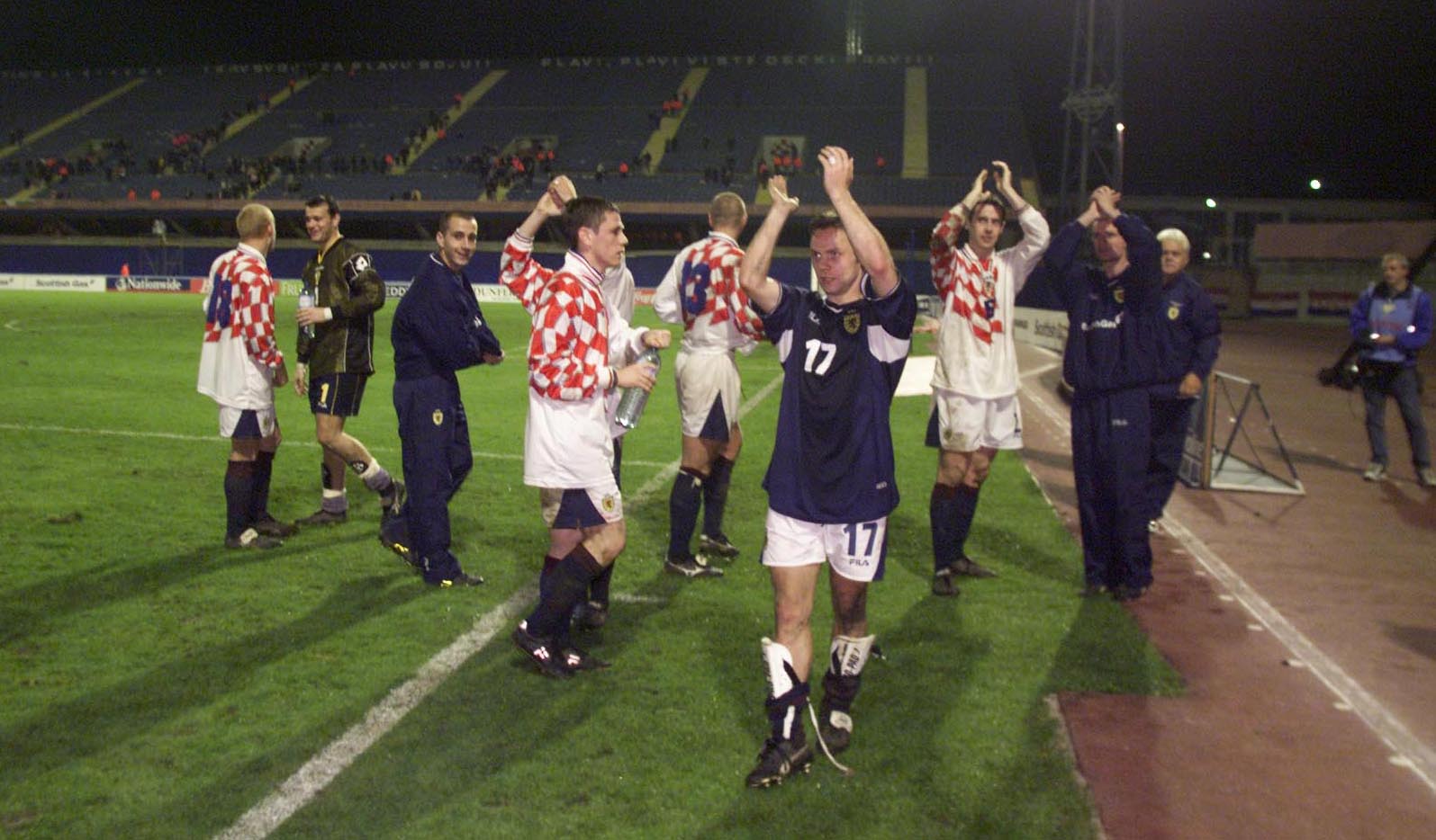 Scotland players salute the travelling Tartan Army.