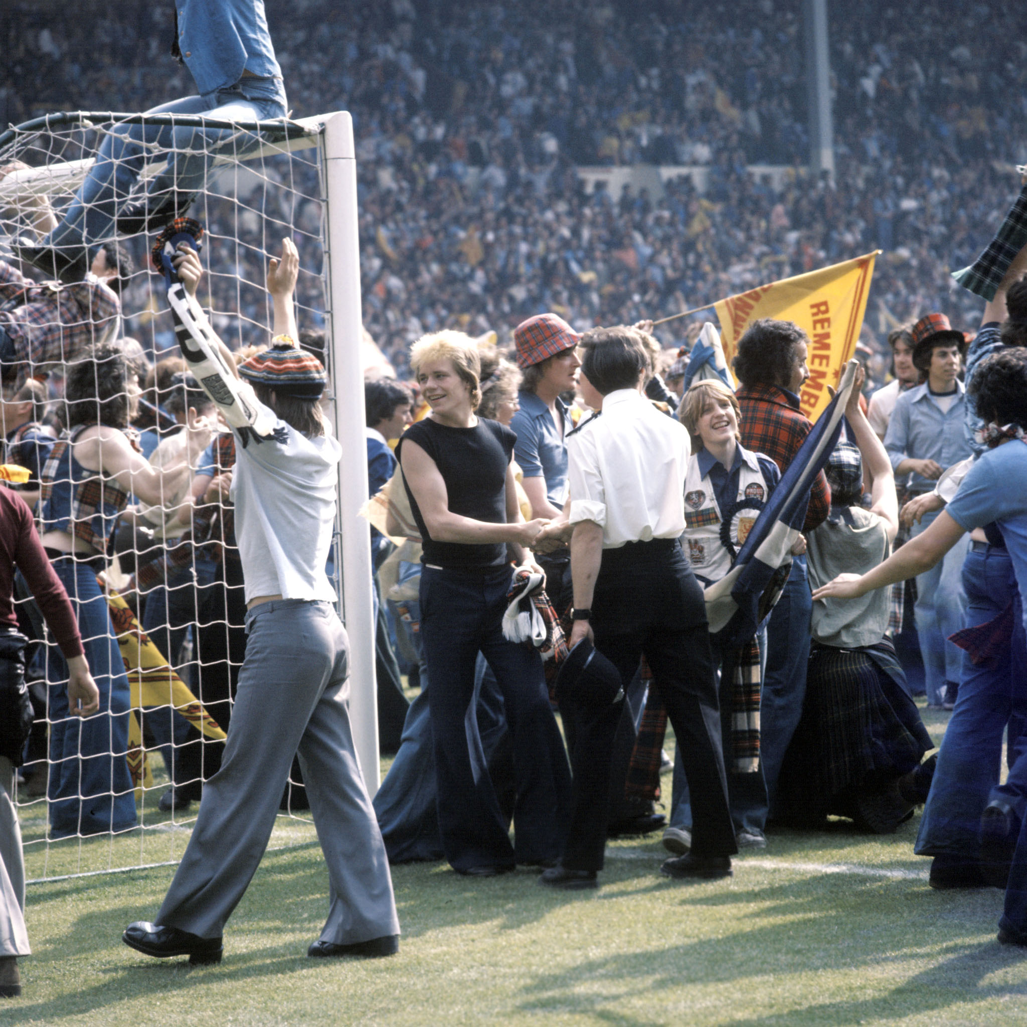 Scotland fans celebrate on the pitch after victory at Wembley in 1977.