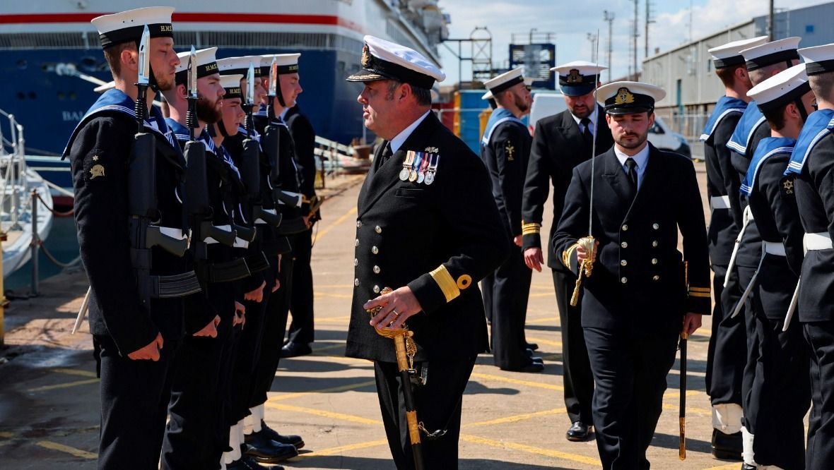 Shipshape: Commodore Tim Neild CBE inspects the guard of honour.