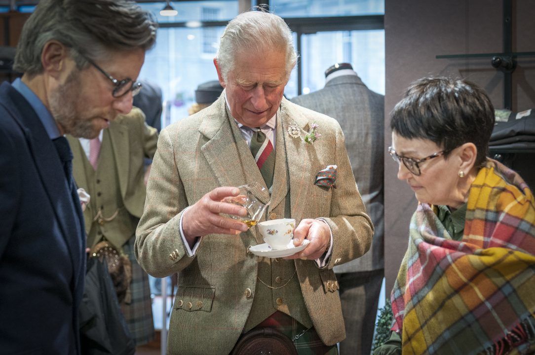 Prince Charles adds whisky to his tea during kilt shop visit