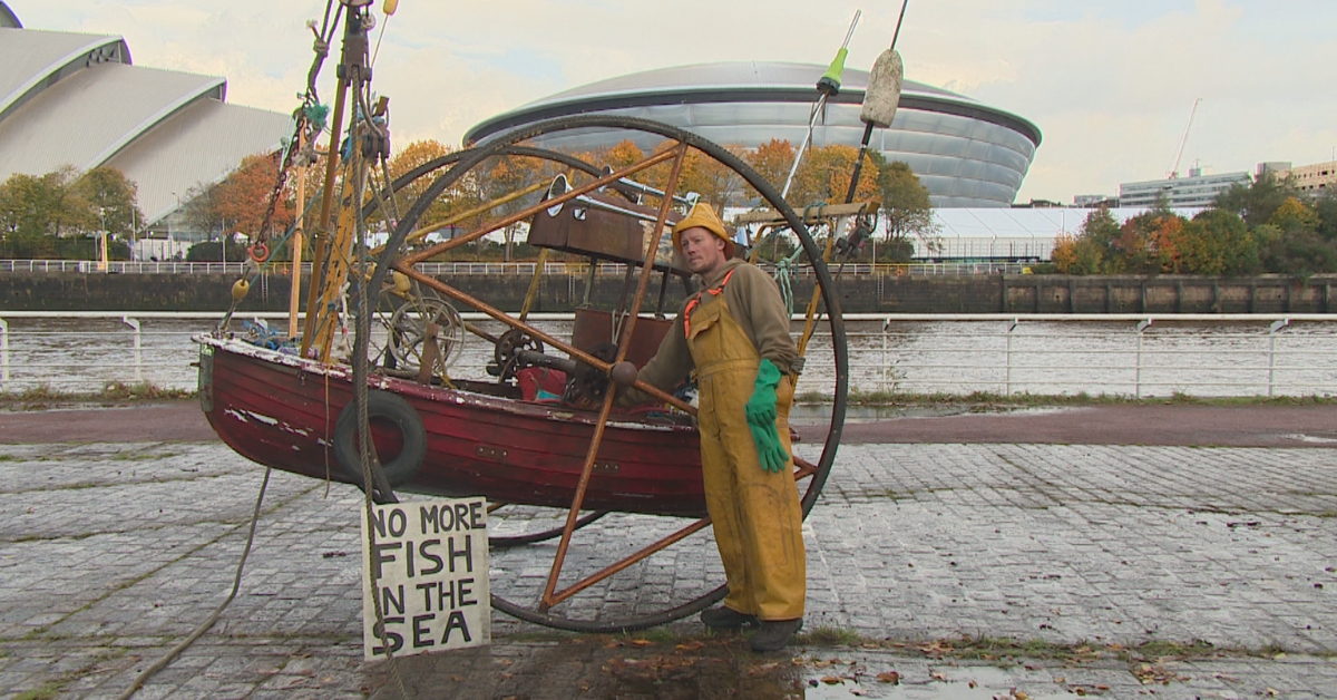 The activists from campaign group Ocean Rebellion staged the theatrical protest on the banks of the Clyde opposite from where the UN climate summit is being held.