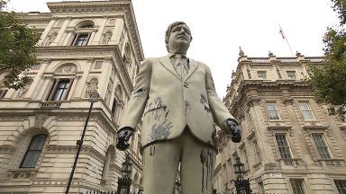Cambo protesters splatter Boris Johnson statue with oil
