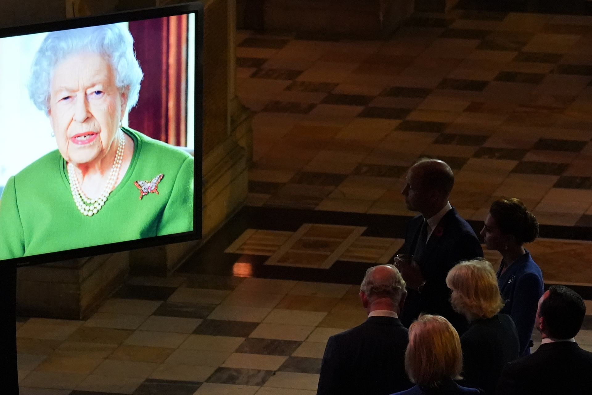 The Prince of Wales and the Duchess of Cornwall watching as the Queen makes a video message.