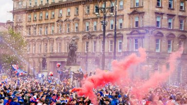 Rangers fan banned from attending matches for five years after throwing items at police during fan title party