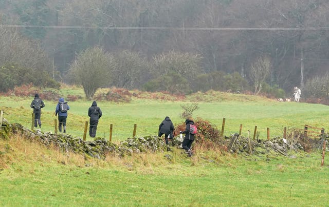 Saboteurs holding spray bottles follow riders and hounds as they take part in the annual hunt (Andrew Milligan/PA)