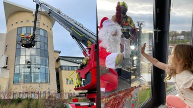 Flying visit: Santa uses cherry picker to greet kids at hospital window