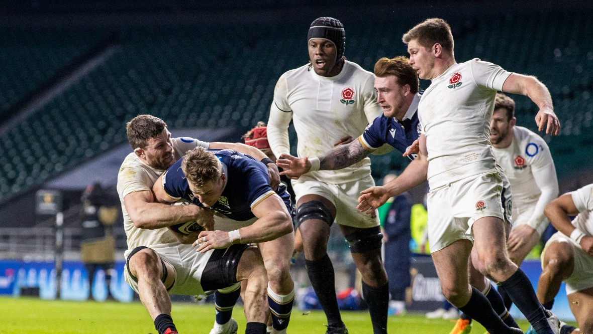 Duhan van der Merwe powers through for Scotland's first try.