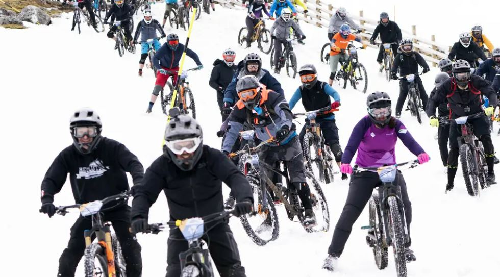 Hundreds of daring mountain bikers in 900m descent of snow-capped mountain