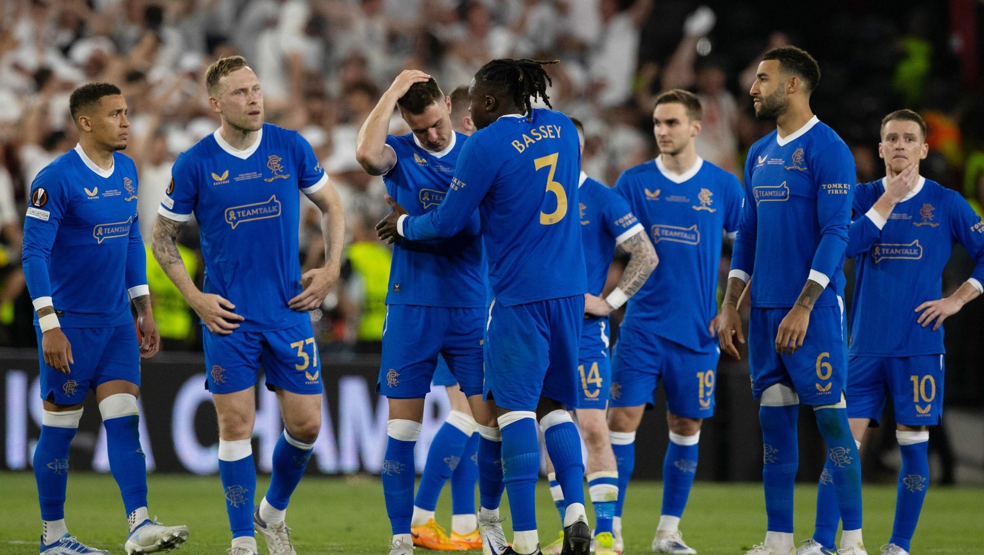 Rangers players console Aaron Ramsey after his vital penalty miss.