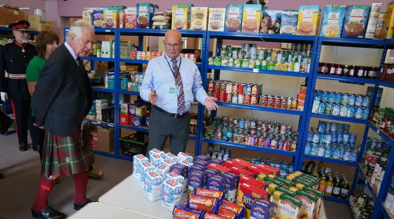 Charles makes donation while visiting Wick-based food bank