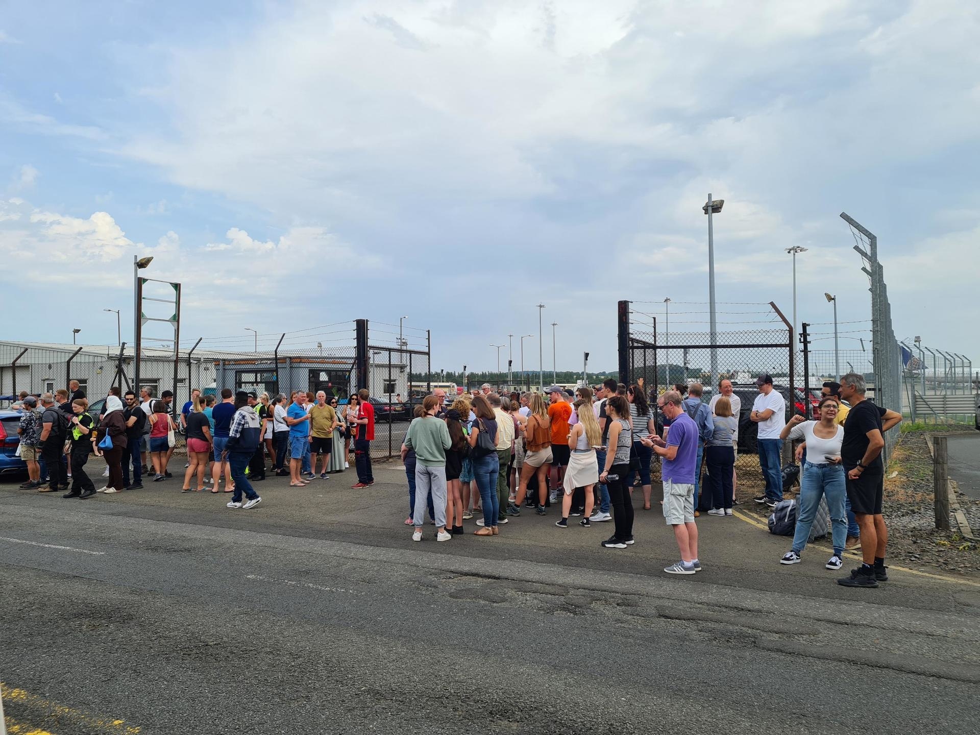 Passengers queued up to collect their luggage on the hottest day of the year. 