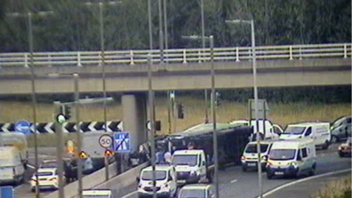 Lorry driver dies after his vehicle overturns on M8 motorway closing road near Edinburgh for 12 hours