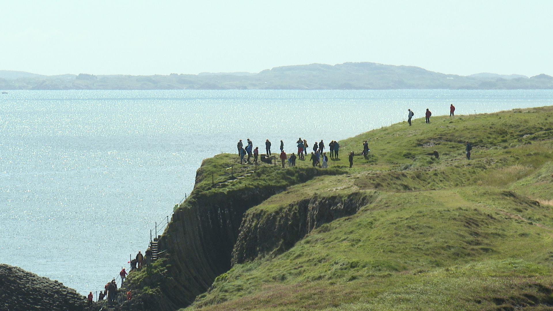 Visitors exploring Staffa. 