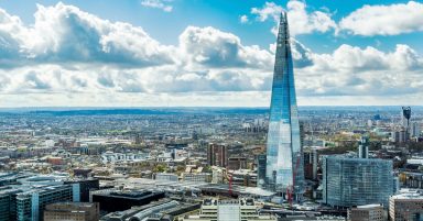 Couple wave at barefoot man climbing past their window at the Shard 40 floors up