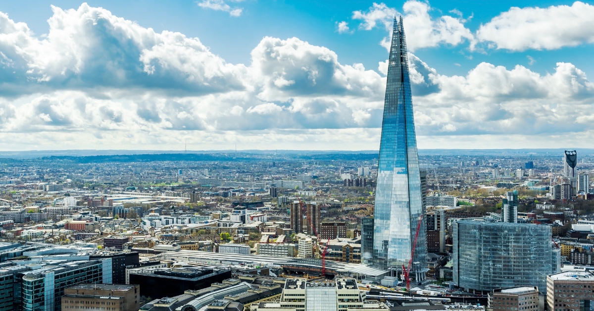 Couple wave at barefoot man climbing past their window at the Shard 40 floors up