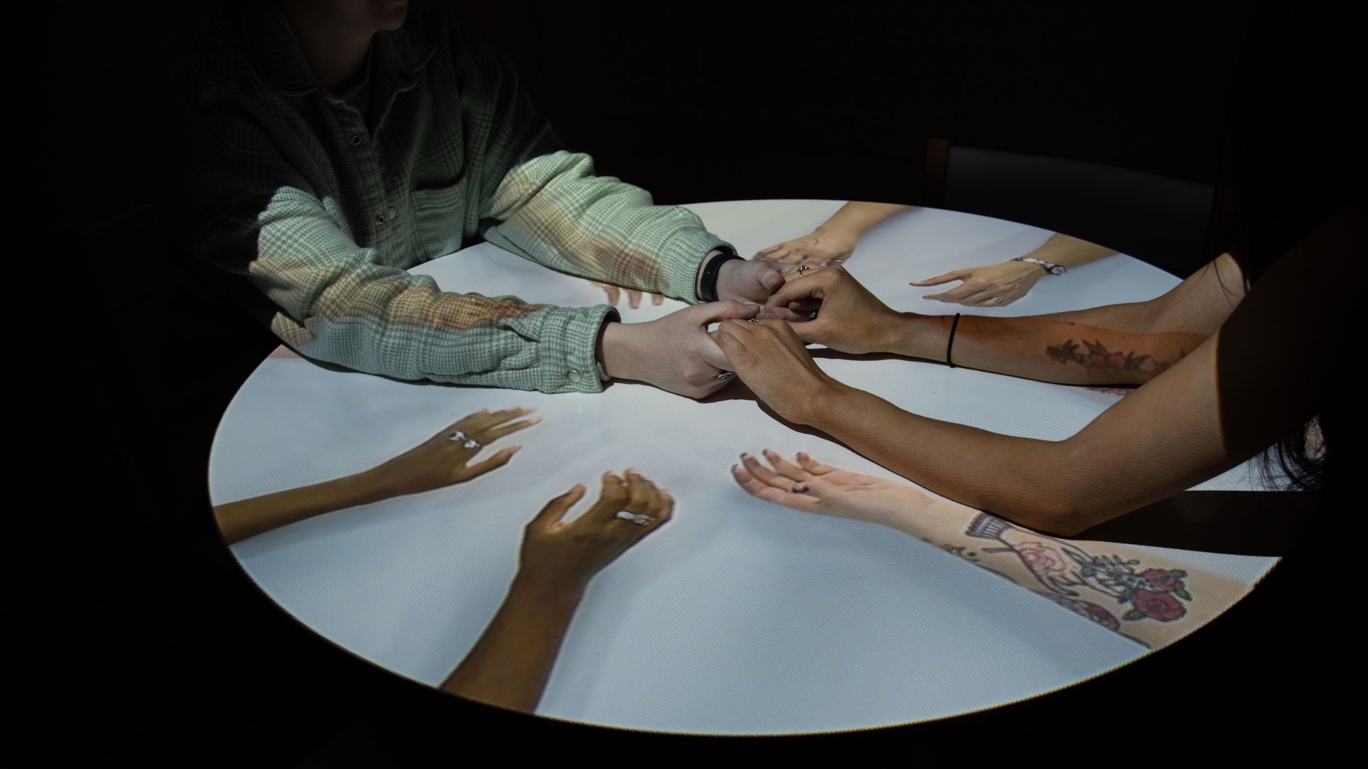 A video filmed and projected from above featured women relaying their lived experience through non-verbal communication.