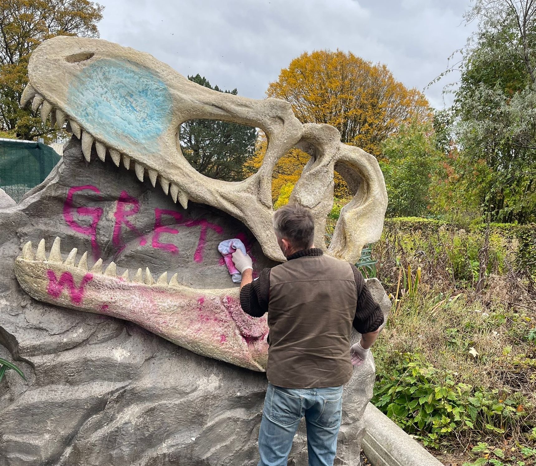 The dinosaur exhibits were written on with pink paint. 