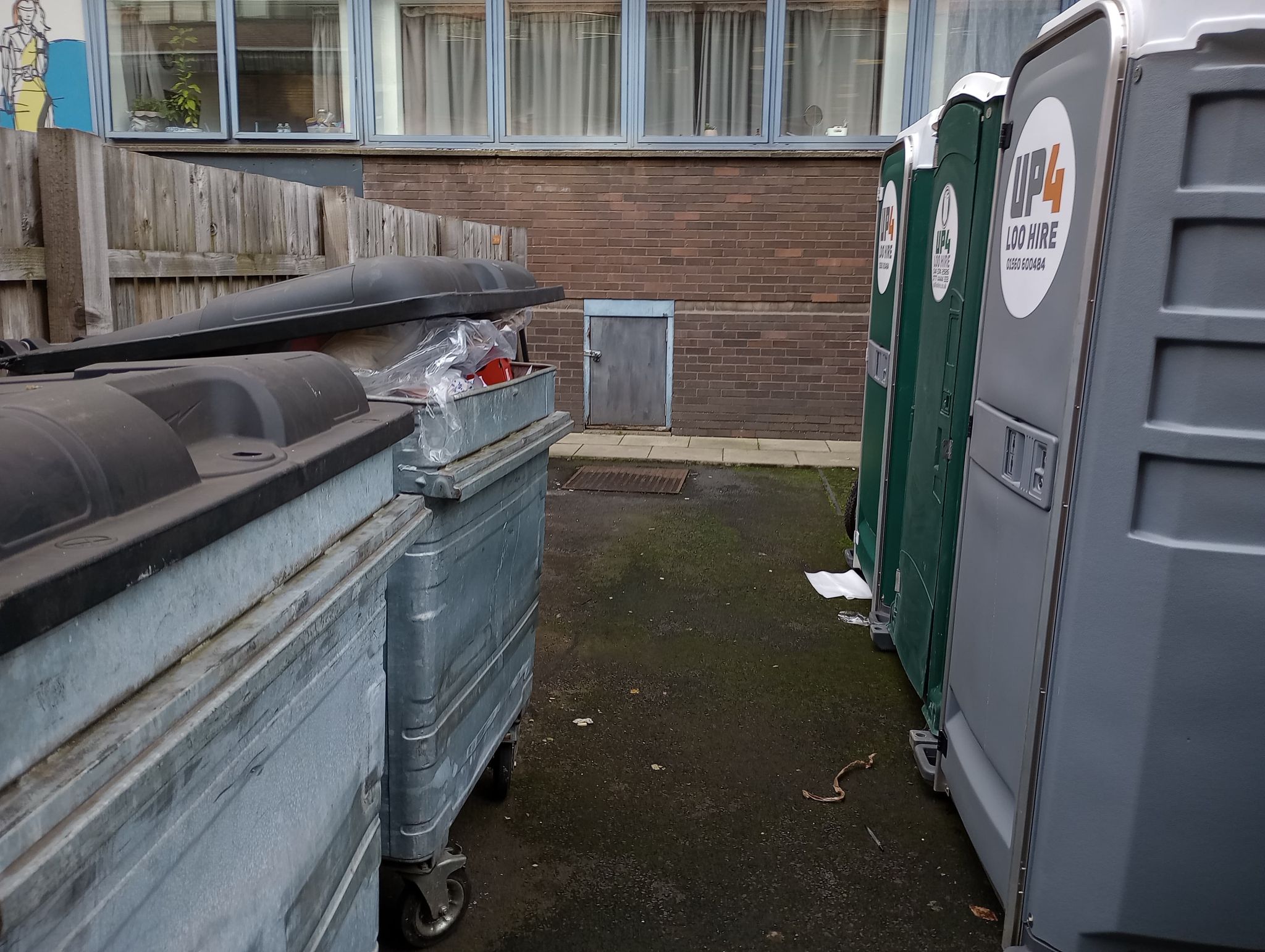 Portable toilets were erected near bins for tenants to use.