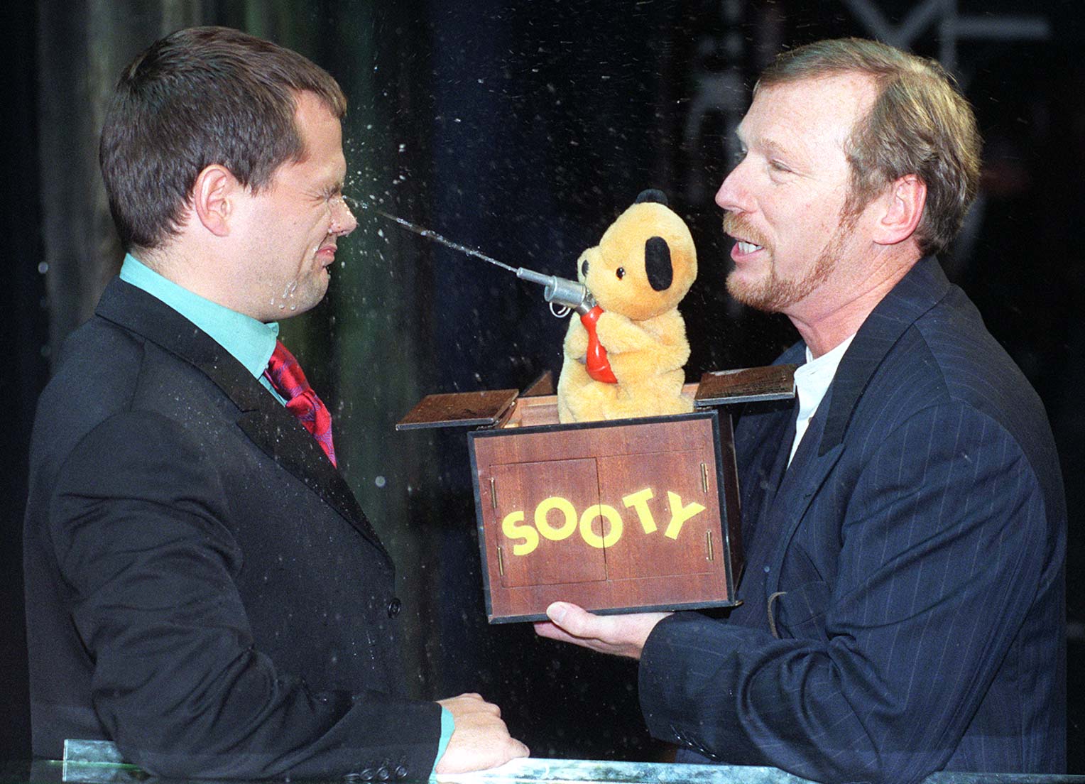 Comedian Jack Dee gets an eyeful from Sooty and puppeteer Matthew Corbett.