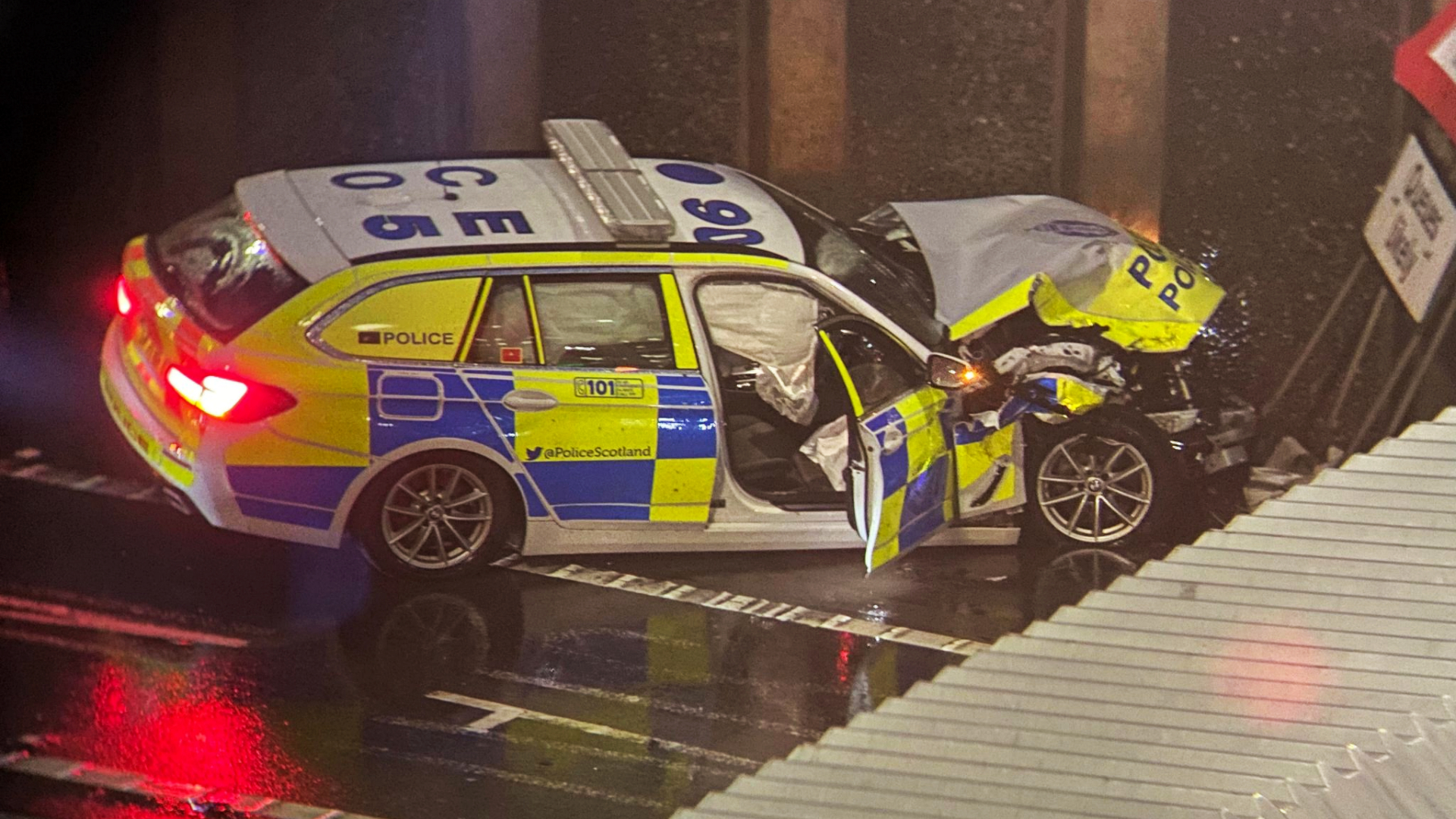 The driver of a police car is in hospital after crashing into a wall after colliding with another vehicle on the M8 motorway in Glasgow.