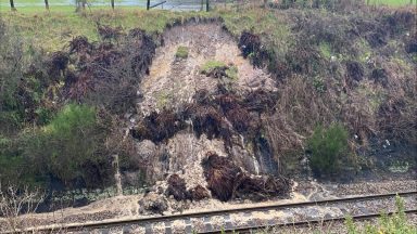 Flooding and weather warnings bring Hogmanay travel issues with trains cancelled and roads submerged