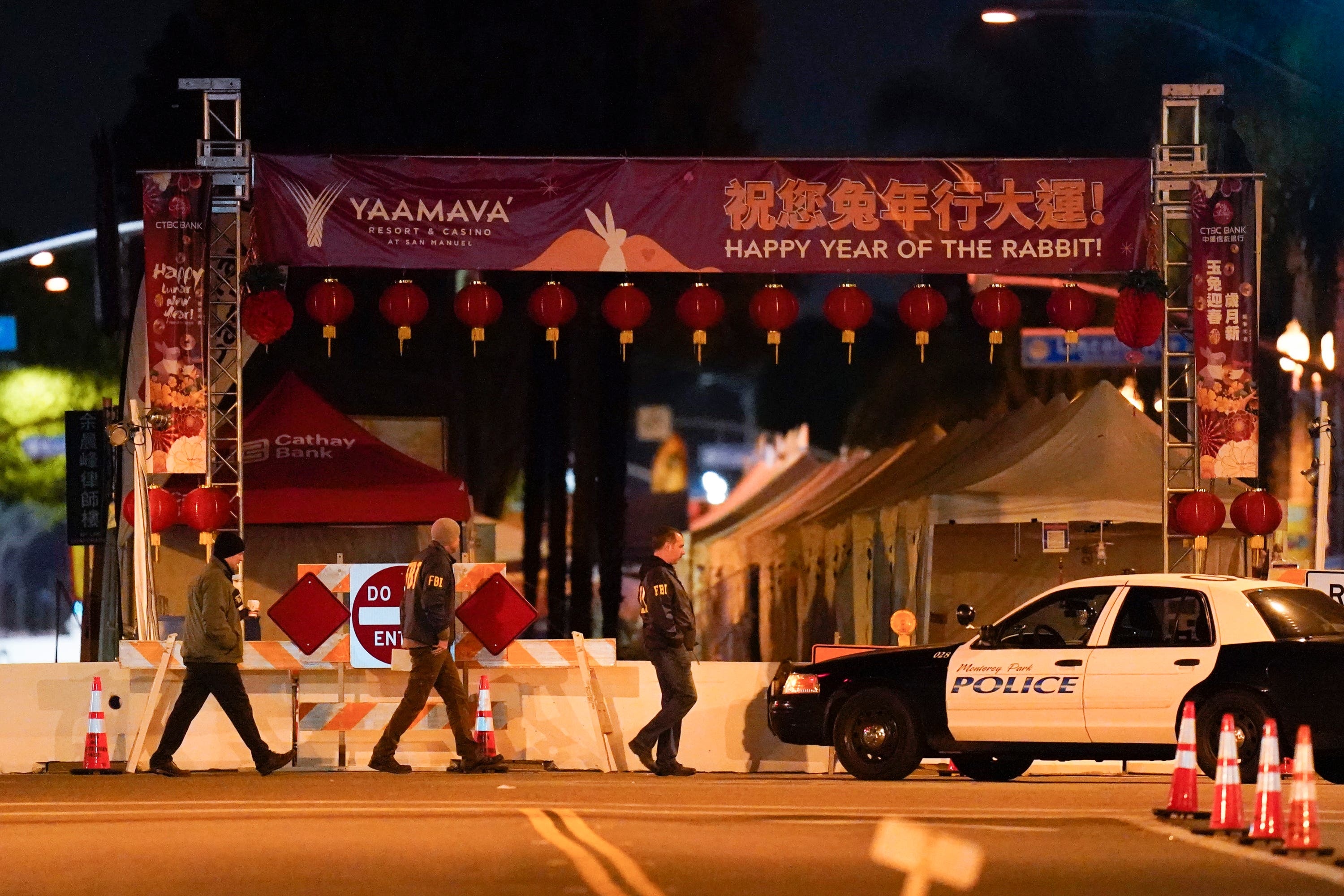 FBI agents walk close to the scene.