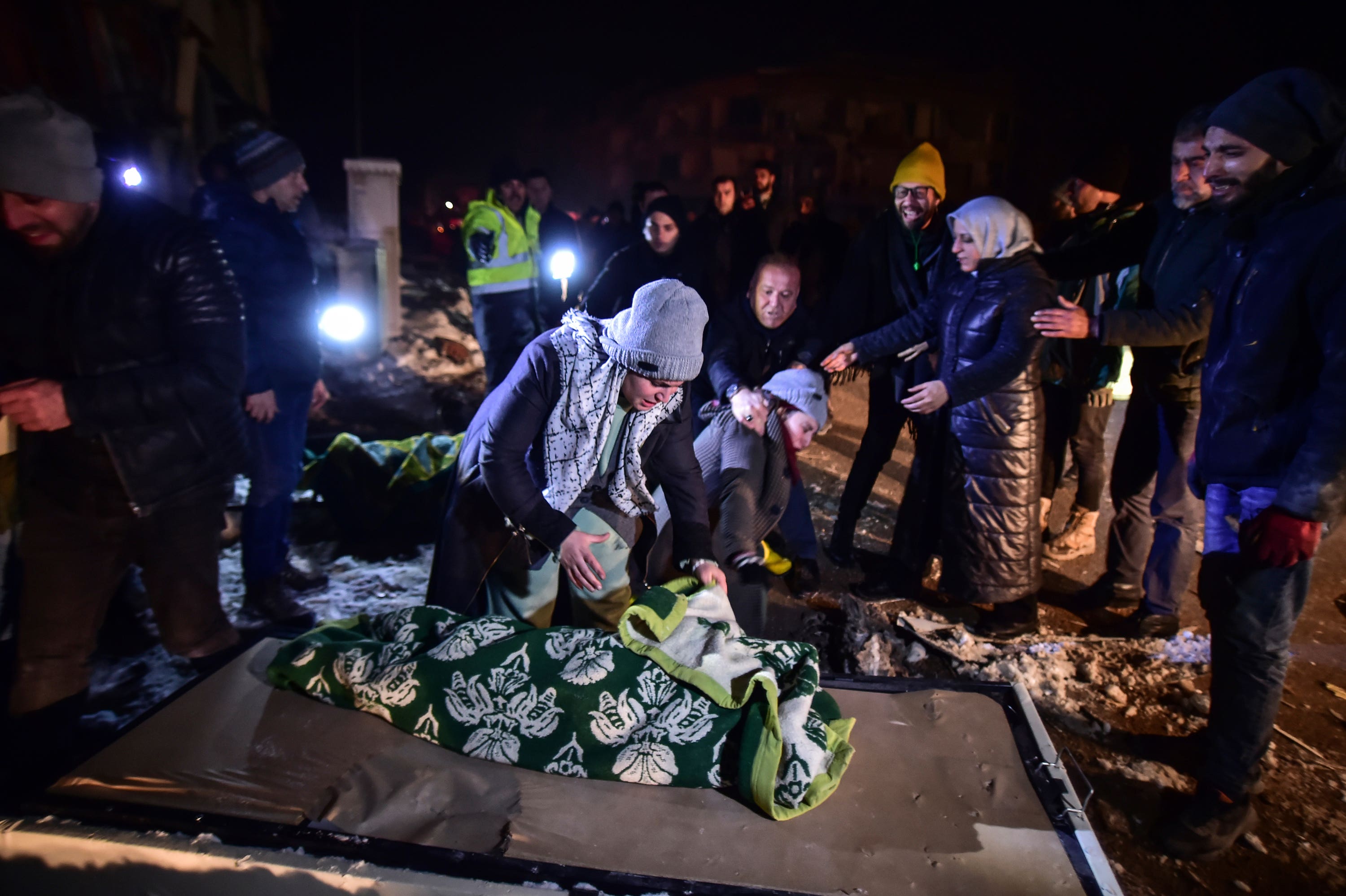 Relatives weep over the dead body of Goktug, a baby boy, in Elbistan, southern Turkey. (Ismail Coskun/IHA/AP)