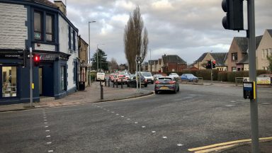 Driver in hospital after ambulance on emergency call crashes into car in Falkirk