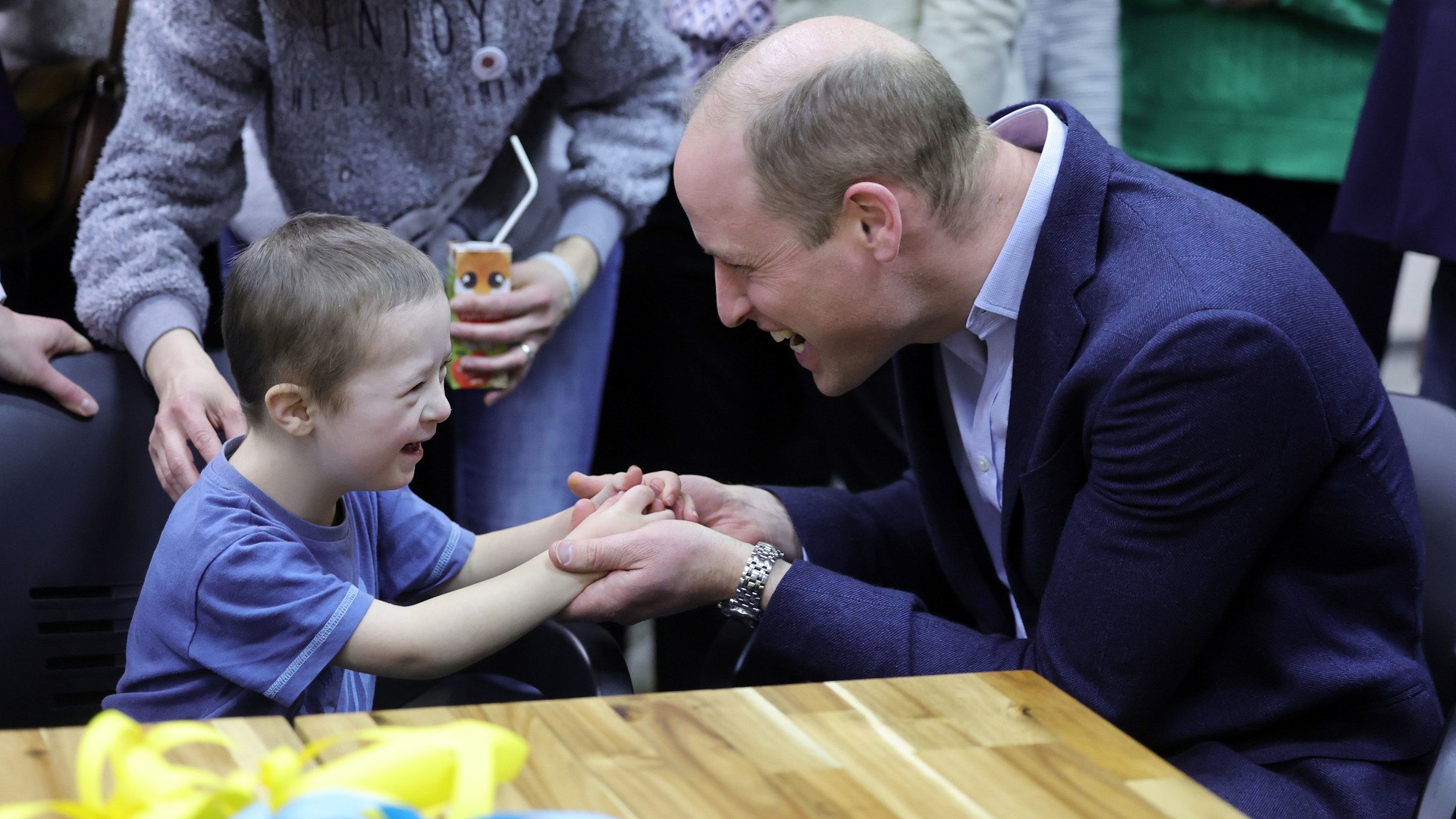 The Prince of Wales plays with Tympthi, aged 4, as he speaks with Ukrainian residents about their experiences of moving to Poland during a visit to a accommodation centre in Warsaw, Poland.