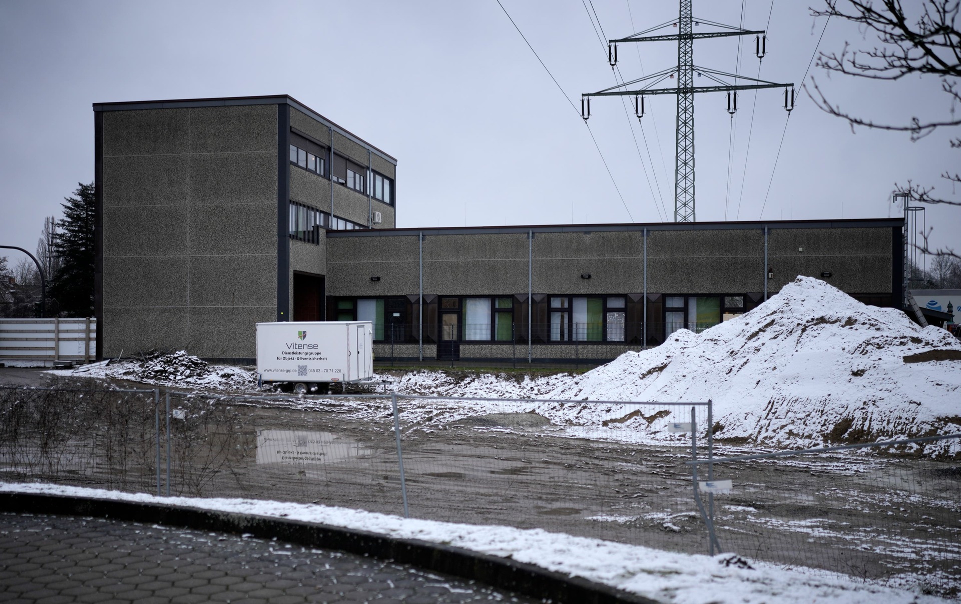 A forensic expert walks beside police outside a Jehovah’s Witness building in Hamburg (Markus Schreiber/AP) 