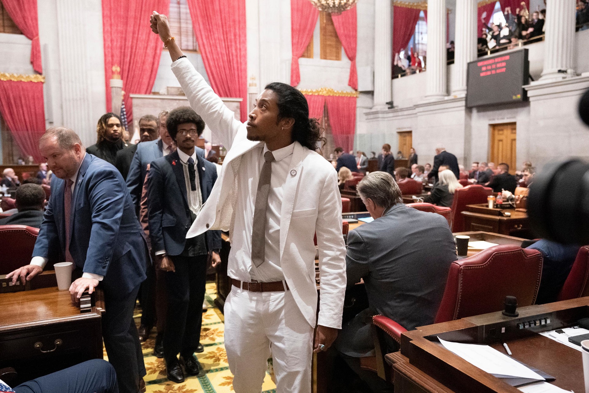 Justin Jones on the floor of the House chamber as he walks to his desk to collect his belongings after being expelled from the legislature.