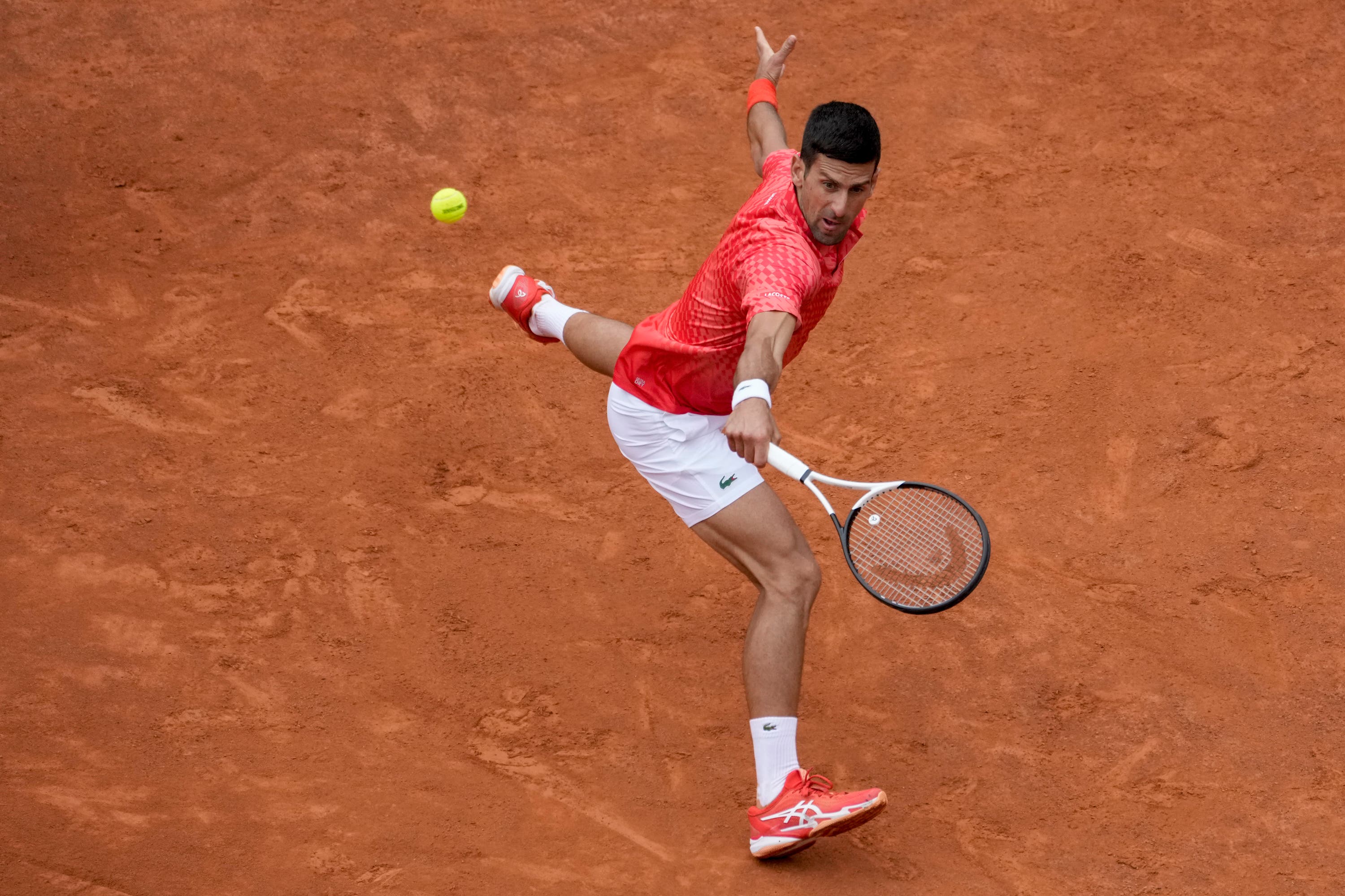 <em>Novak Djokovic slides into a backhand (Andrew Medichini/AP)</em>”/><cite class=cite></cite></div><figcaption aria-hidden=true><em>Novak Djokovic slides into a backhand (Andrew Medichini/AP)</em> <cite class=hidden></cite></figcaption></figure><p>Norrie withstood pressure after the smash incident to hold his serve until 4-4, when Djokovic, who has never failed to make the quarter-finals in Rome, made the decisive move.</p><p>The 35-year-old was serving noticeably slower than usual but he was coy on the reason for a visit to the treatment room that delayed the start of the match.</p><p>“Every day is something,” he said. “Thankfully I was able to play and finish the match, so hopefully tomorrow I will feel even better.”</p><p>Djokovic next faces a quarter-final clash with seventh seed Holger Rune, who defeated Alexei Popyrin in three sets, while fifth seed Stefanos Tsitsipas completed a delayed 6-3 7-6 (3) victory over Italian Lorenzo Sonego.</p><div class=