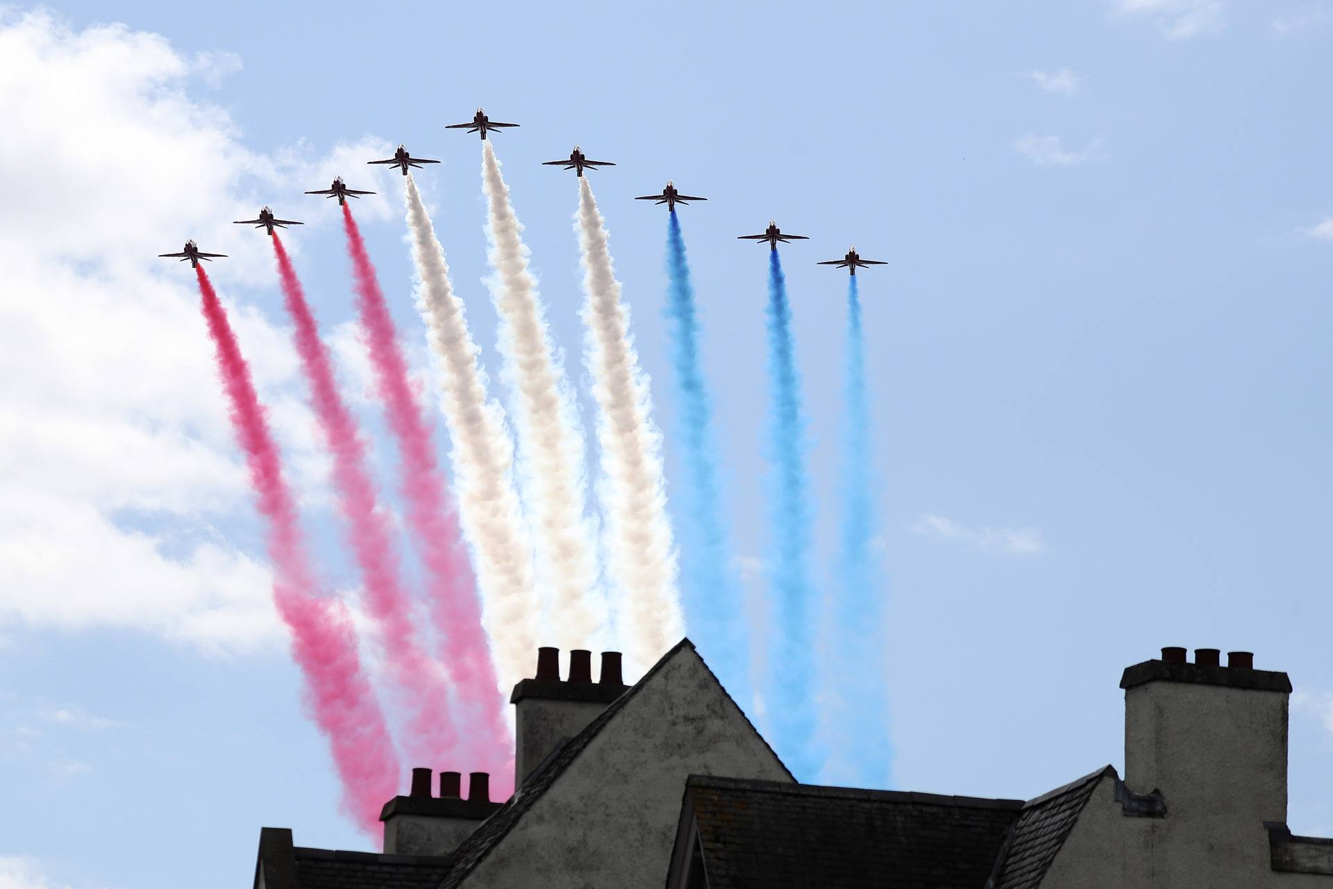 The Royal Airforce Red Arrows fly past after the national service of thanksgiving and dedication.