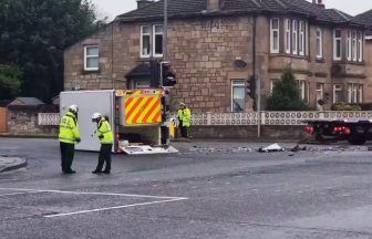 Patient and paramedics rushed to hospital after ambulance flips onto side in Glasgow London Road crash