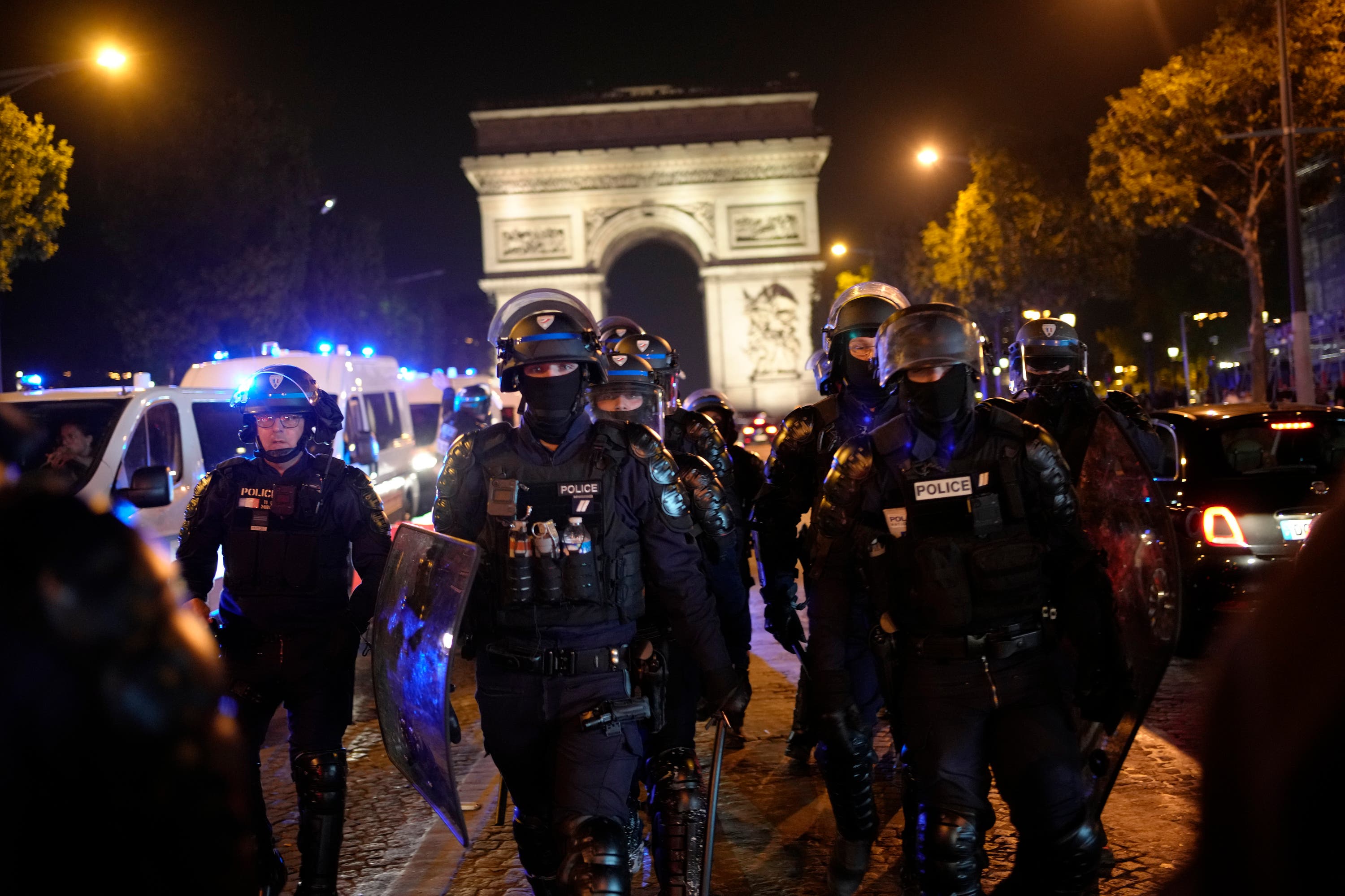 Police officers patrol in front of the Arc de Triomphe on the Champs Elysees on Saturday evening (AP Photo/Christophe Ena)