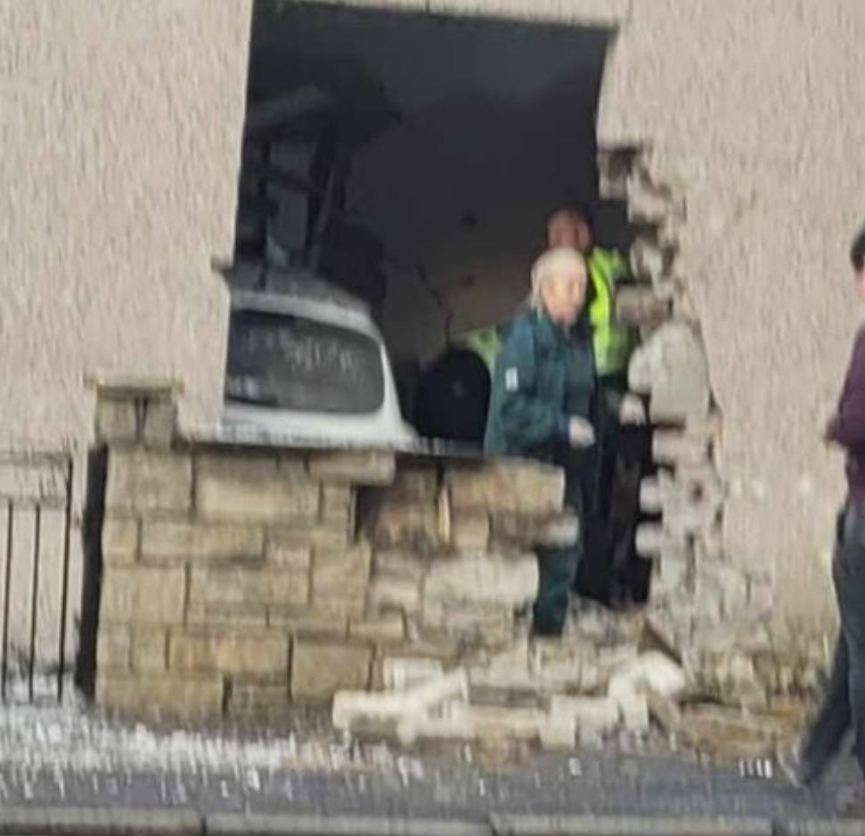 Images on social media appear to show a white car crashed through a wall, inside the house.