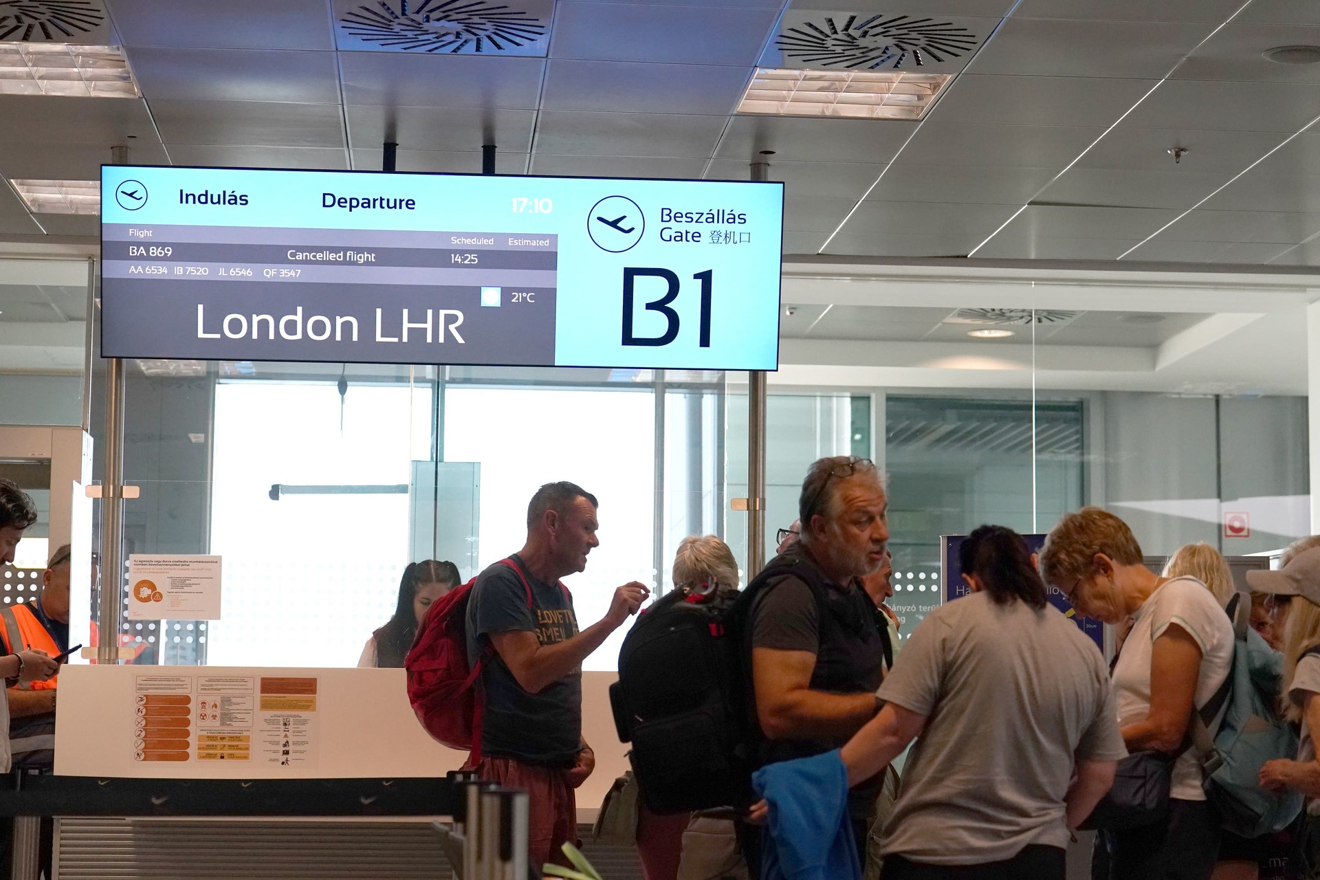 Passengers wait at a departure gate at Ferenc Liszt International Airport in Budapest, Hungary, as flights to the UK and Ireland were cancelled.