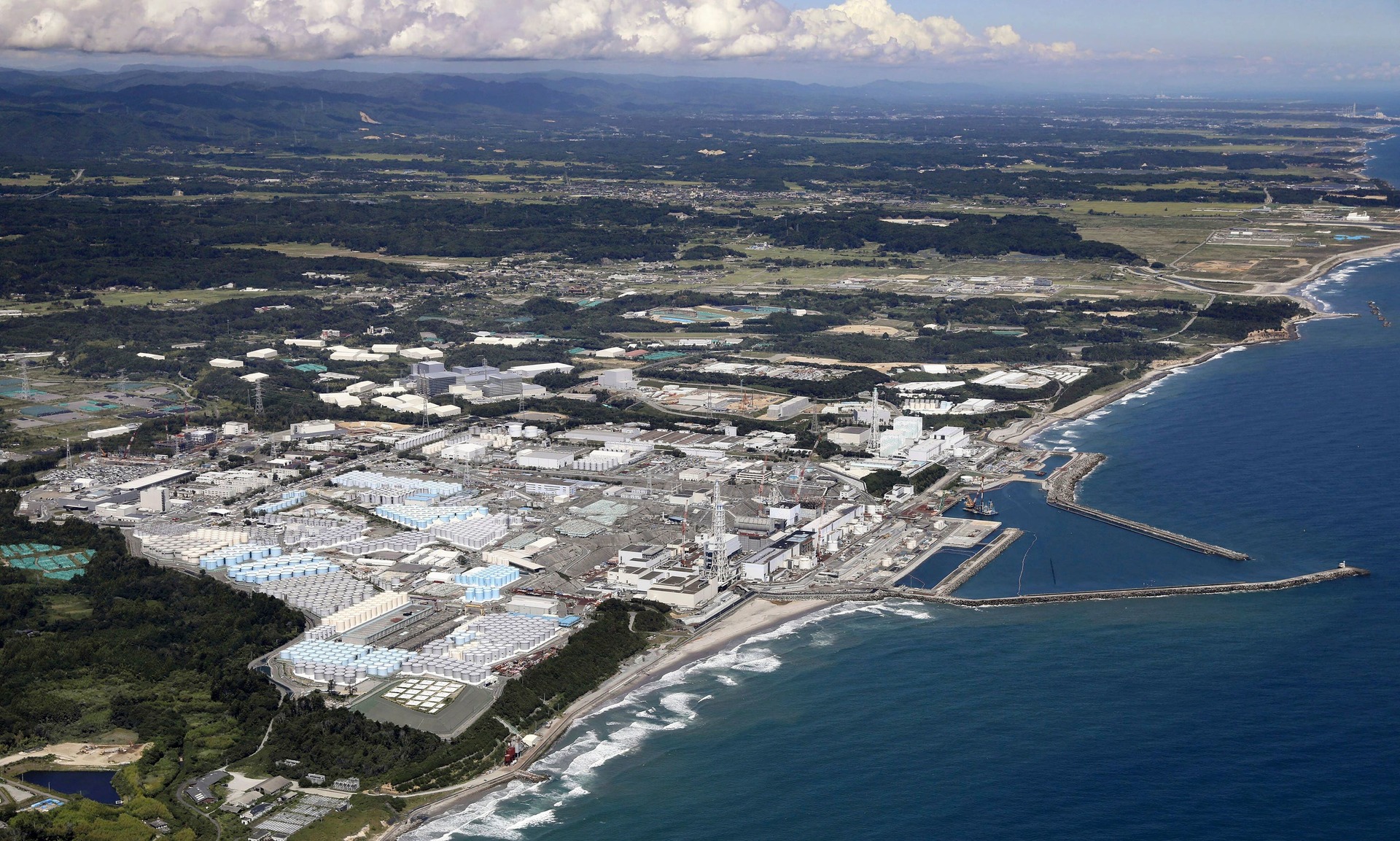 This aerial view shows the tanks, seen foreground, which contain treated radioactive wastewater at the Fukushima Daiichi nuclear power plant in Fukushima, northern Japan.