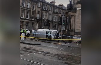 Edinburgh car rolls on to side at Haymarket bend as police rush to shut down road