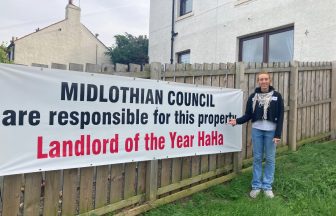 Sign shaming council hung as resident suffers sewage leaks in Midlothian