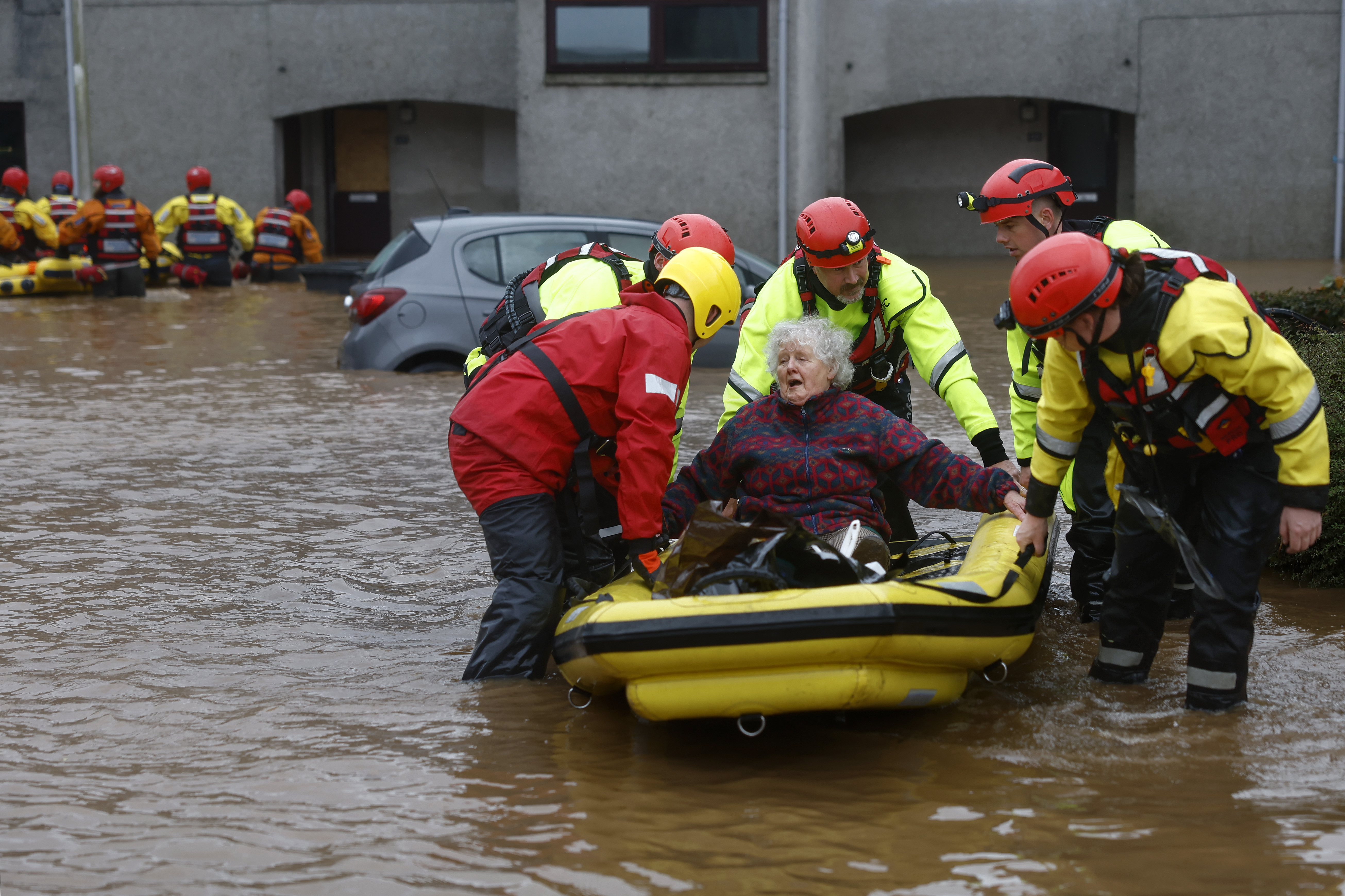 Members of the Coastguard rescue a woman from flood waters surrounding the houses on October 20, 2023 in Brechin.