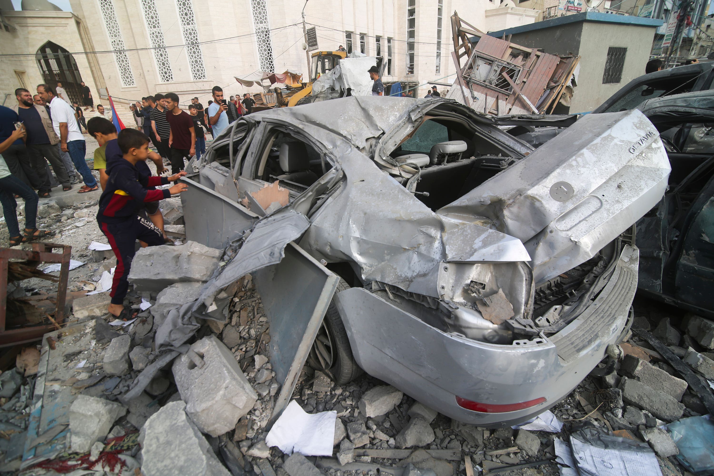 Palestinians inspect the damage after Israeli airstrikes in Khan Younis in the Gaza Strip (Hatem Ali/AP) 