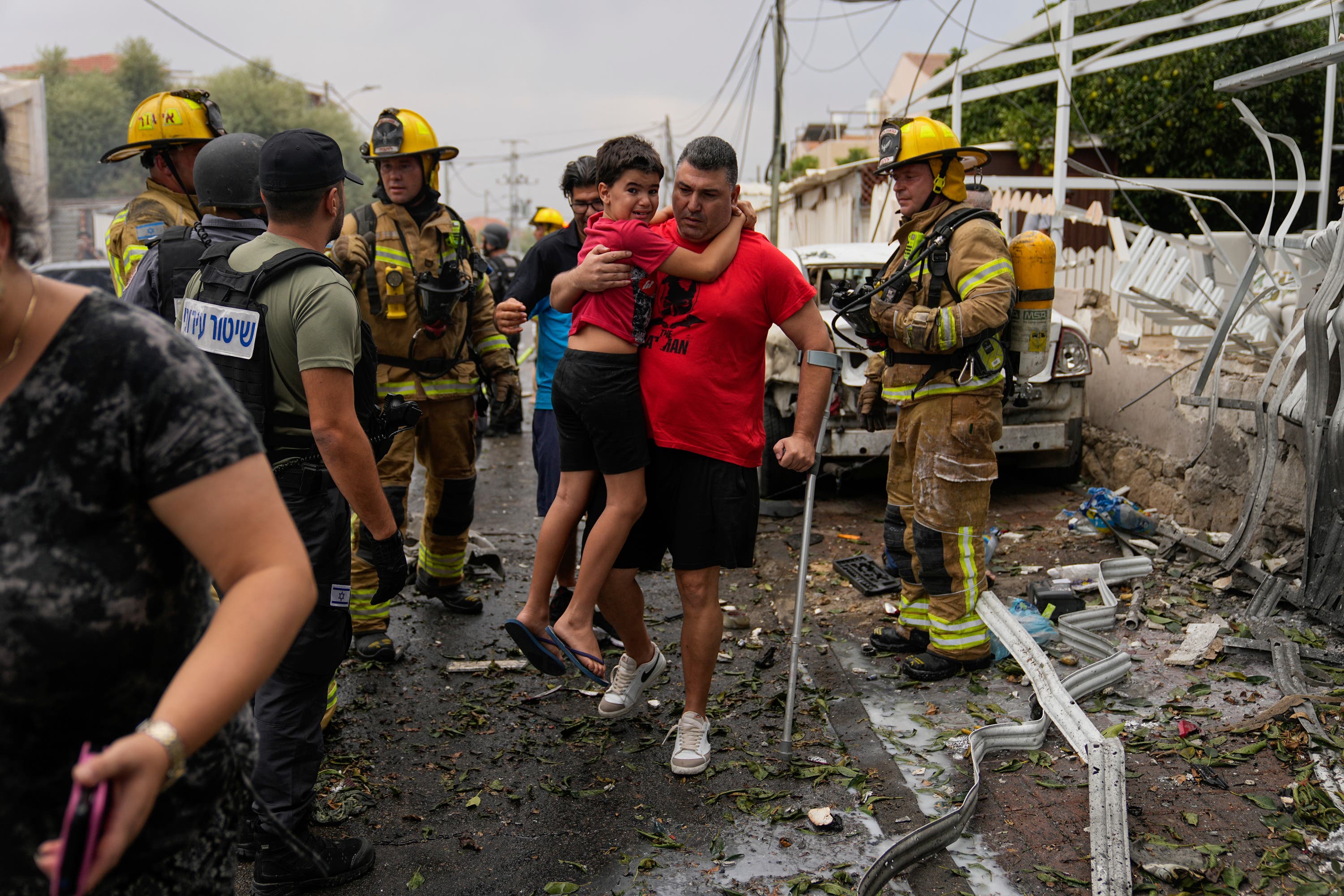 Israelis evacuate a site struck by a rocket fired from the Gaza Strip, in Ashkelon, southern Israel, on Monday.