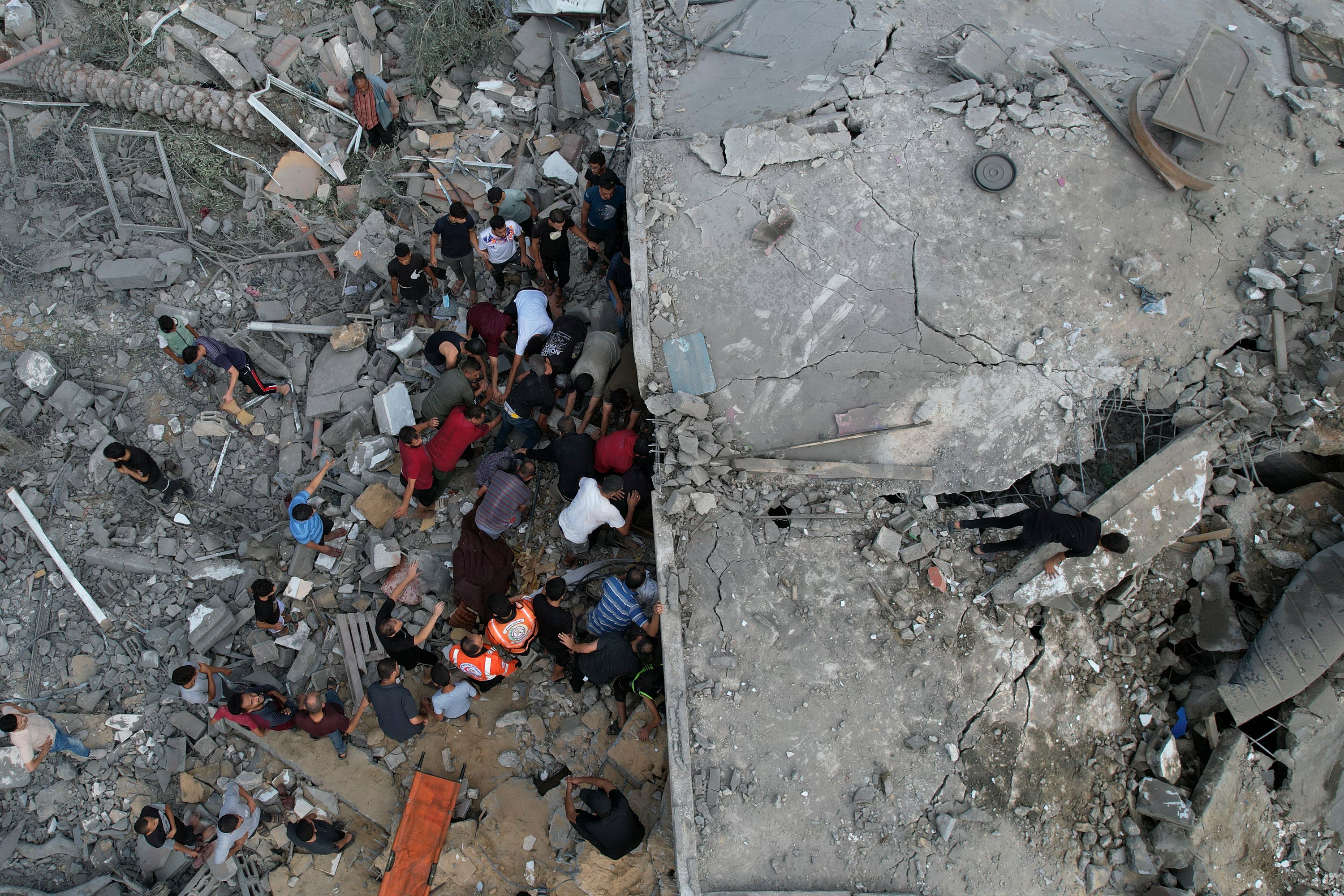 Palestinians look for survivors after an attack in Gaza.